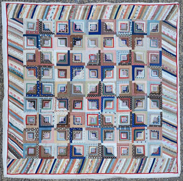 An American patchwork quilt 'log cabin' design, concentric squares in various foliate and coloured panels, within a matching, angles wide border, line