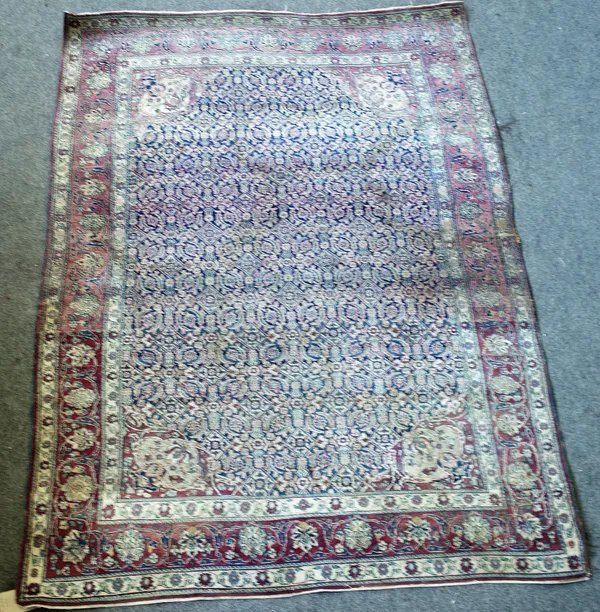 A pair of Teheran rugs, Persian, the indigo field with an allover intricate herate design, large palmette madder spandrels; a madder palmette and vine