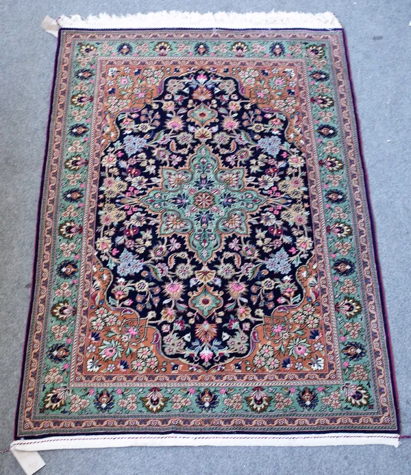 A pair of part silk Kashan rugs, Persian, each indigo field with a sage medallion, brown spandrels, all with abundantly floral sprays; a sage palmette