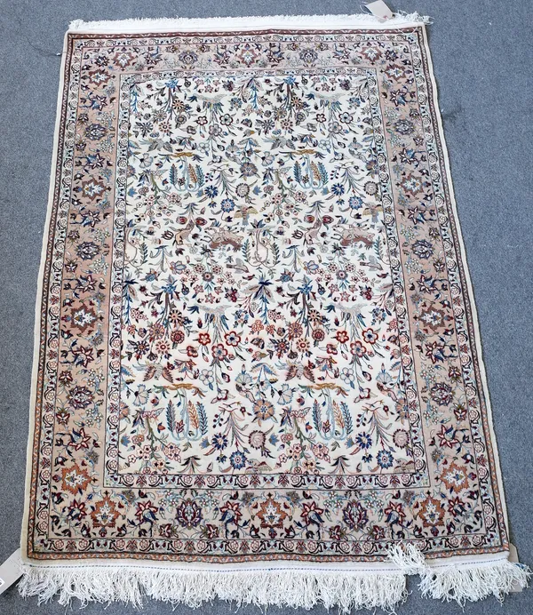 A part silk Esfahan garden rug, Persian, the cream field with an allover floral design, deer and birds; a beige floral border, 171cm x 114cm.