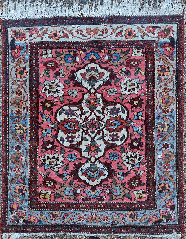 A Mahal rug, the rose madder field with an ivory pole medallion, floral sprays, a pale indigo palmette and vine border, 116cm x 95cm. Illustrated.