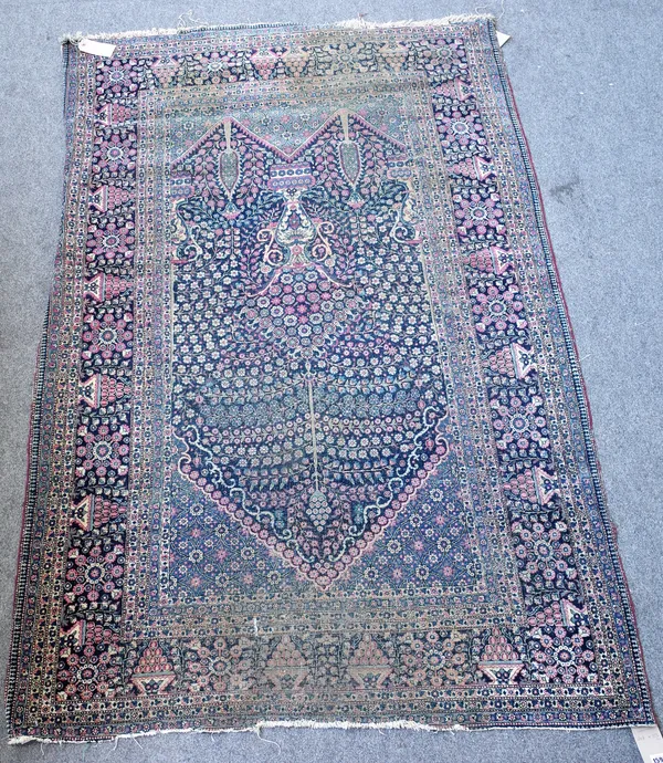 A Teheran prayer rug, Persian, the dark indigo mehrab filled with miniature flowers, a central vase and two tress, a flower arch above, a dark indigo