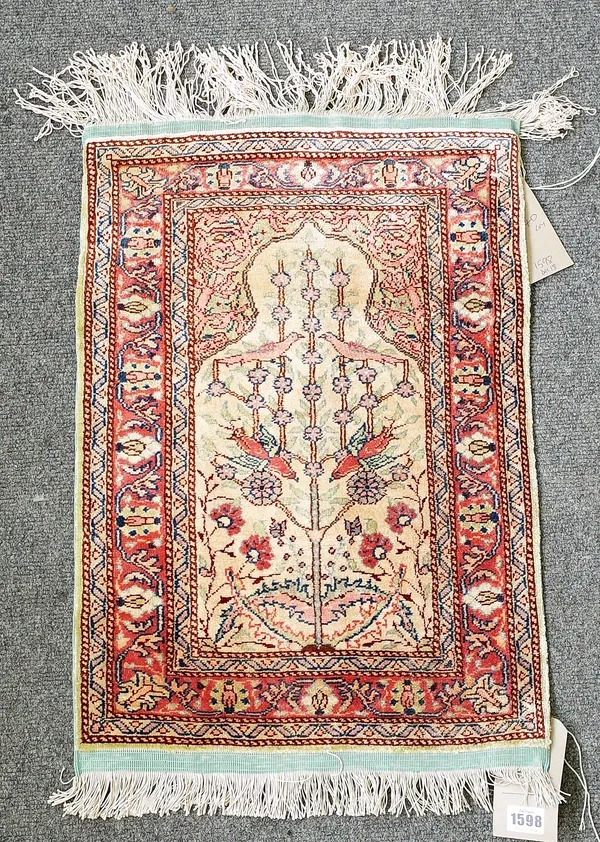 A small silk Keyseri prayer mat, Turkish, the 'gold' mehrab with a tree of life, minor madder border, 60cm x 40cm.