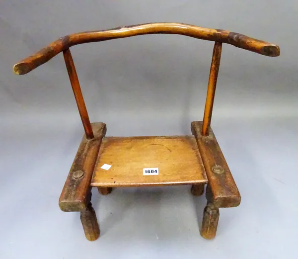 A primitive child's chair, with bow back and solid seat, 44cm wide x 43cm high.