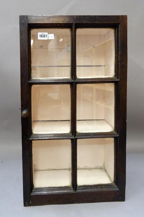 An 18th century and later oak glazed hanging cupboard, 34cm wide x 61cm high.