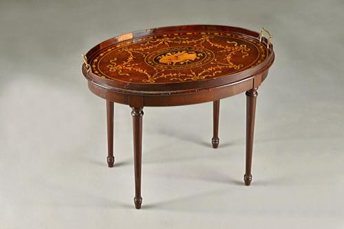 An Edwardian marquetry inlaid galleried oval serving tray, on later stand, 68cm wide x 50cm high. Illustrated.