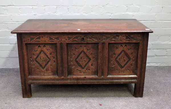 A 17th century oak coffer with carved triple panel front, 103cm wide x 56cm high.