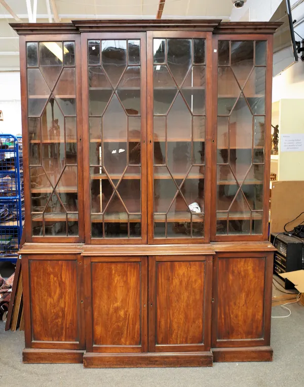 A George III mahogany breakfront bookcase cabinet, the four astragal glazed doors over four cupboards, 191cm wide x 246cm high.