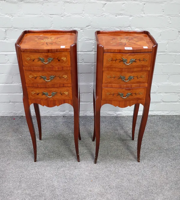 A pair of Louis XV style marquetry inlaid three drawer bedside tables on cabriole supports, 28cm wide x 74cm high.