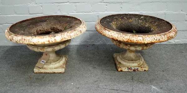 A pair of early 20th century white painted cast iron jardinieres, with shallow lobed bodies, 48cm diameter x 38cm high, (2).