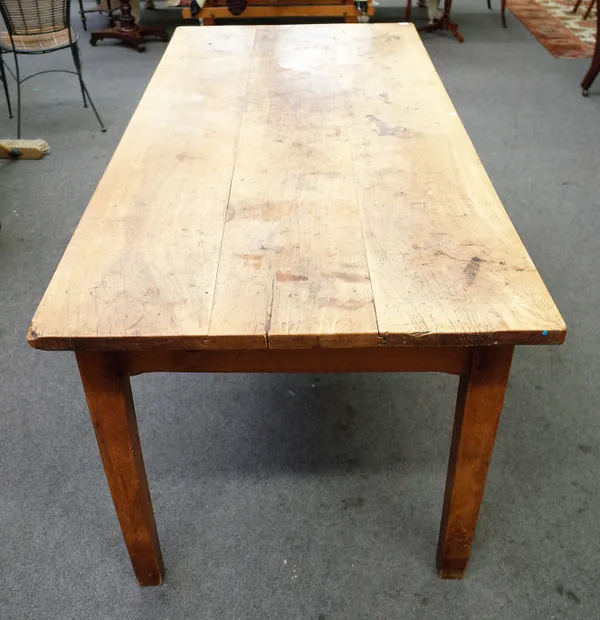A 19th century French cherrywood plank top kitchen table, with single frieze drawer on tapering square supports, 85cm wide x 195cm long.