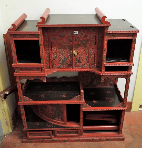 A late 19th century Chinese red lacquer polychrome painted Shodana on stand, 93cm wide x 150cm high.