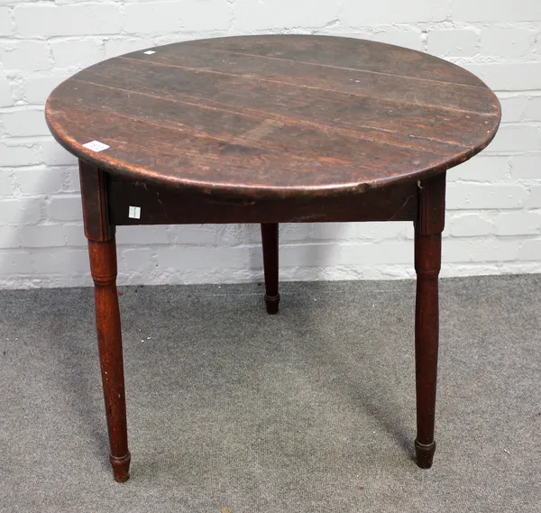A George III oak cricket table, the circular top on three turned supports, 70cm diameter  x 70cm high.