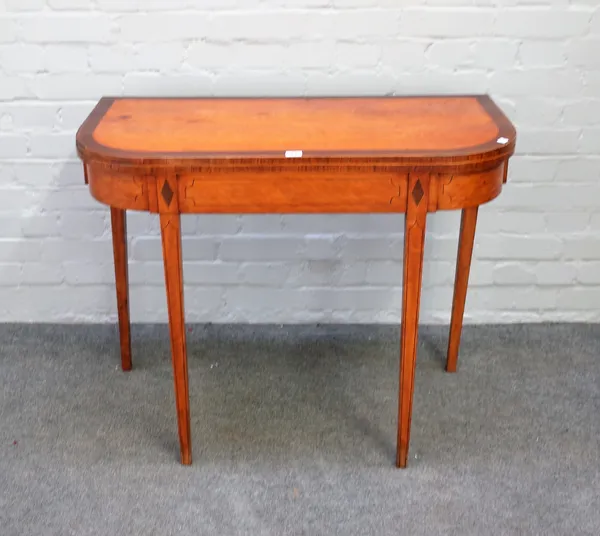 A George III mahogany banded satinwood 'D' shaped card table on tapering square supports, 92cm wide x 74cm high.