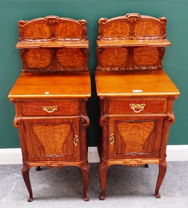 Eugene Gaillard; a pair of figured ash and walnut bedside tables, each with ledge back over single drawer and cupboard, on cabriole supports, 47cm wid