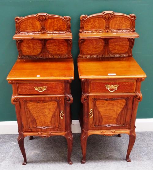Eugene Gaillard; a pair of figured ash and walnut bedside tables, each with ledge back over single drawer and cupboard, on cabriole supports, 47cm wid