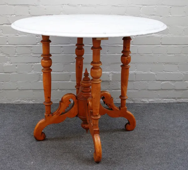 A circular marble topped centre table on three turned satin birch supports, united by shaped and pierced stretcher, 90cm diameter x 76cm high.