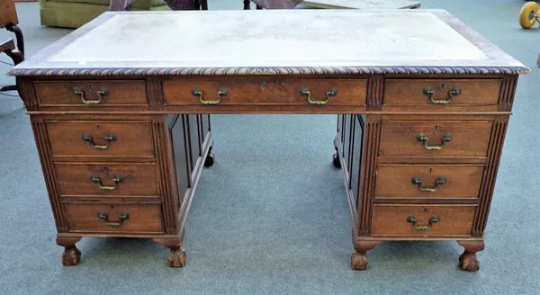 An early 20th century mahogany pedestal desk, with nine drawers about the knee, on claw and ball feet, 152cm wide x 91cm deep.