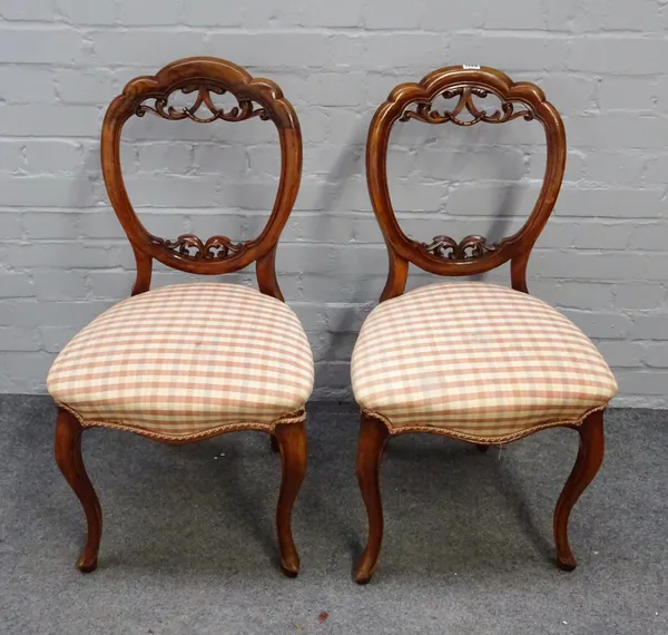 A set of four Victorian walnut balloon back dining chairs with serpentine seats, 45cm wide x 86cm high.