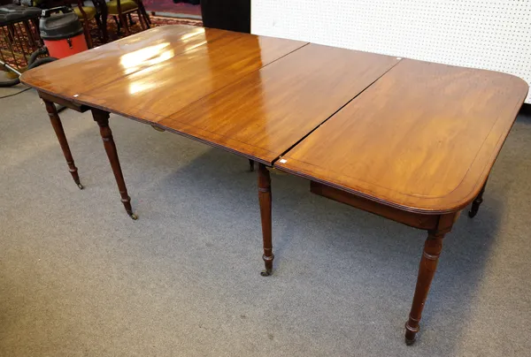 A late George III mahogany 'D' end extending dining table, on turned supports, with two extra leaves, 115cm wide x 114cm long x 220cm long extended.