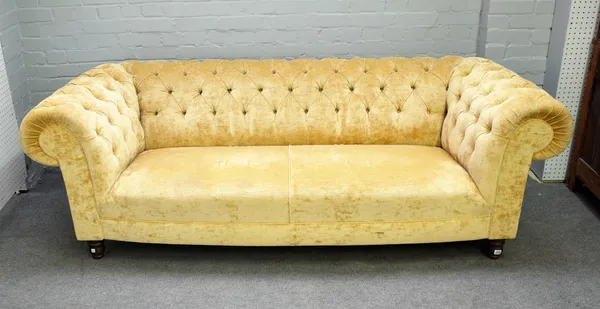 A Chesterfield sofa with buttoned gold upholstery on turned supports, 222cm wide x 74cm high.