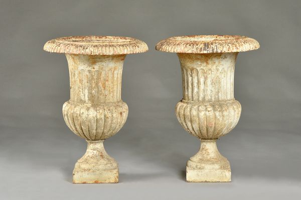 A pair of early 20th century white painted cast iron jardinieres, with fluted bodies, 41cm diameter x 56cm high, (2). Illustrated.