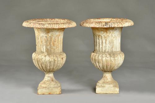A pair of early 20th century white painted cast iron jardinieres, with fluted bodies, 41cm diameter x 56cm high, (2). Illustrated.