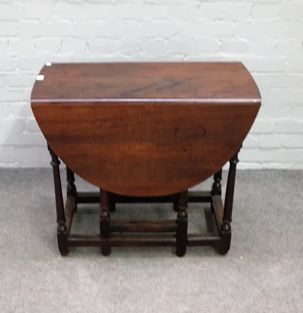 A small late 17th century oak gate leg table on turned supports, 76cm wide x 68cm high.