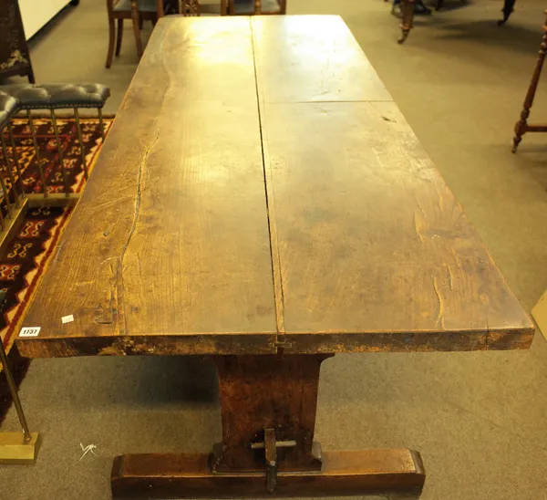 An 18th century and later oak refectory table, on trestle end standards, 85cm wide x 217cm long.