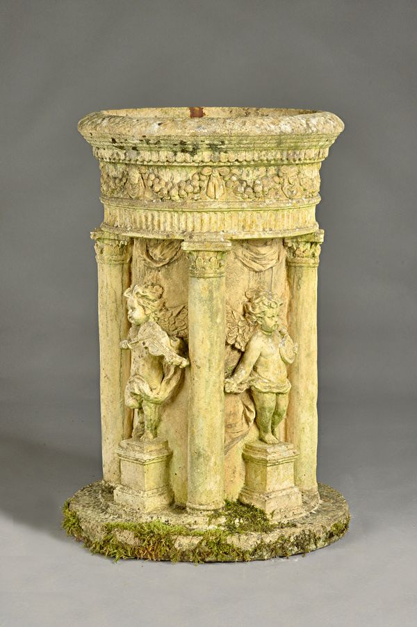 A reconstituted stone water fountain, relief cast with cherubs divided by columns, 50cm diameter x 80cm high. Illustrated.