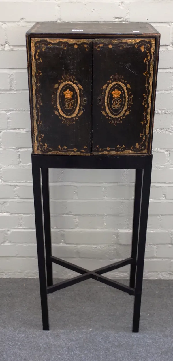 An early 19th century Chinese export black lacquer and gilt decorated table cabinet, the pair of doors enclosing six drawers on later stand, the cabin