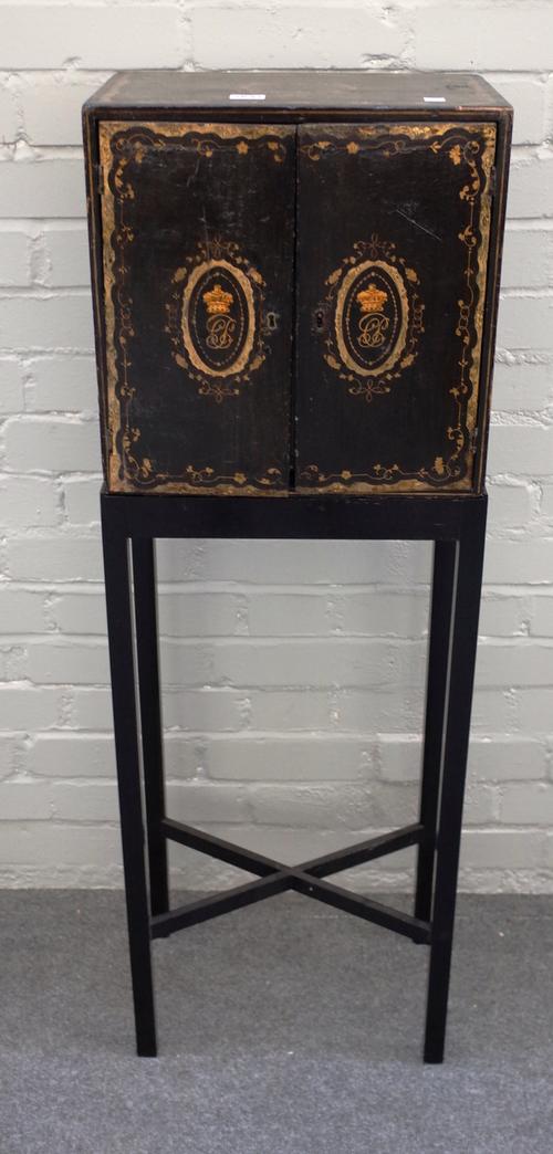 An early 19th century Chinese export black lacquer and gilt decorated table cabinet, the pair of doors enclosing six drawers on later stand, the cabin