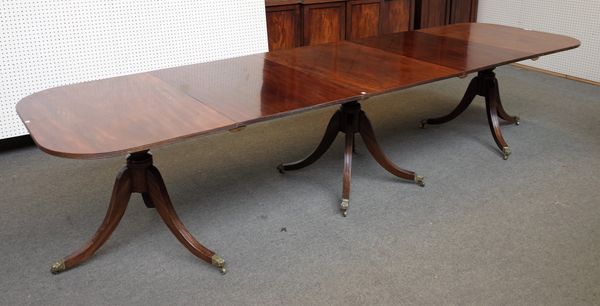 A Regency style mahogany triple pillar extending dining table on ten downswept supports, two extra leaves 99cm wide x 215cm long x 350cm fully extende