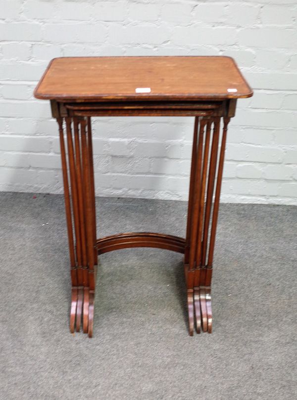 A nest of four Regency satinwood banded rosewood occasional tables on turned supports, the largest 52cm wide x 75cm high.