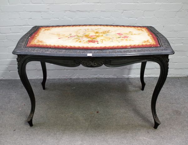 A Victorian ebonised centre table of serpentine outline on cabriole supports, 80cm wide x 125cm long.