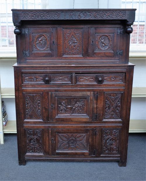 A late 17th century carved oak Didarn/court cupboard, with pair of cupboards over drawer and two further cupboards, 134cm wide x 185cm high.
