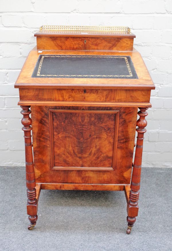 A Victorian figured walnut Davenport with fitted superstructure over four side drawers on turned front supports, 54cm wide x 94cm high x 53cm deep.