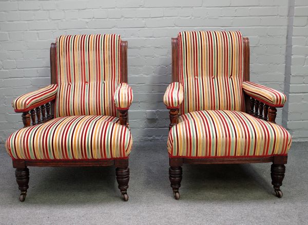 A pair of Victorian mahogany framed open arm easy chairs on turned supports, 75cm wide x 94cm high,