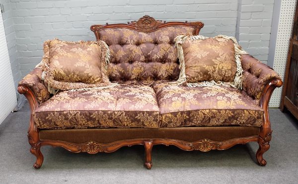 A 20th century hardwood framed sofa on six scroll supports, 205cm wide x 108cm high.