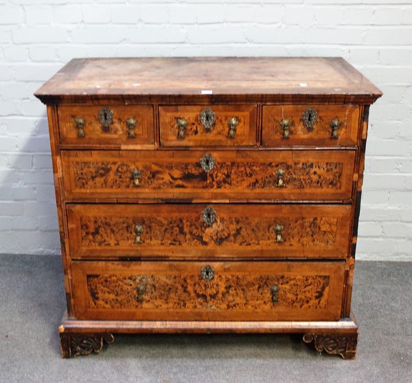 A George I walnut banded burr elm chest of three short over three long graduated drawers on later bracket feet, 103cm wide x 95cm high.