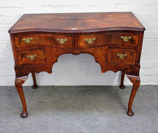 A mid-18th century style figured walnut lowboy, with four drawers about the knee, on pad feet, 97cm wide x 76cm high.