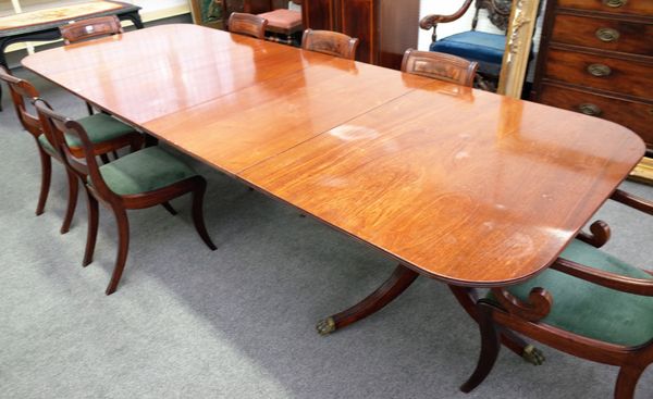 A George III style mahogany twin pillar extending dining table, on six downswept supports, with a pair of extra leaves, 114cm wide x 182cm long x 302c