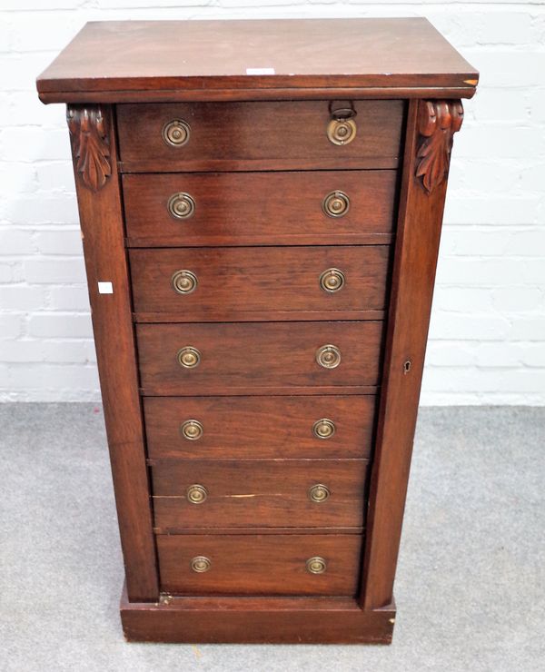 A Victorian mahogany Wellington chest of seven drawers, enclosed by locking bar, 51cm wide x 104cm high.