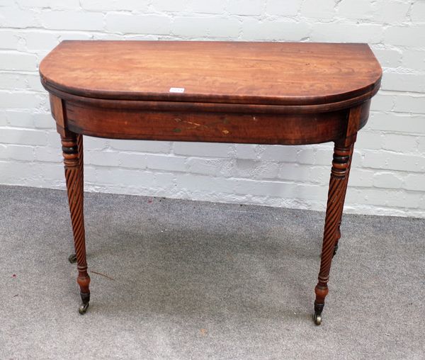 A George IV brass inlaid mahogany foldover tea table on spiral fluted supports, 91cm wide x 74cm high.