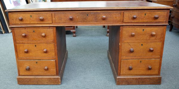 A Victorian oak pedestal desk with nine drawers about the knee, on plinth base, 137cm wide x 76cm deep.