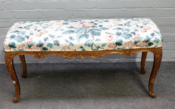 A Victorian rectangular gilt framed footstool of George III style, 105cm wide x 50cm high.