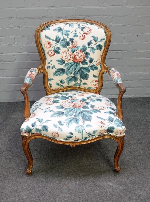 A George III gilt framed open armchair with serpentine seat on scroll supports, 65cm wide x 91cm high.