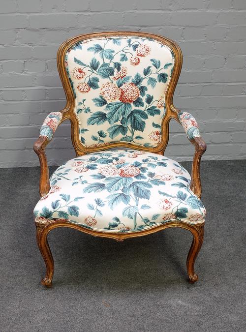 A George III gilt framed open armchair with serpentine seat on scroll supports, 65cm wide x 91cm high.