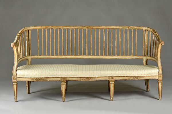 A late 18th century Italian polychrome painted pine slat back sofa with double serpentine seat, on tapering square supports, 185cm wide x 86cm high. I