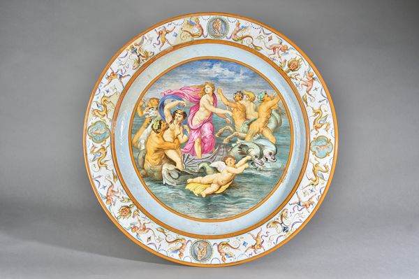 A large  Minton earthenware charger by Emile Lessore, circa 1860, in Urbino style, painted with The Triumph of Venus, with Venus drawn in a scallop sh